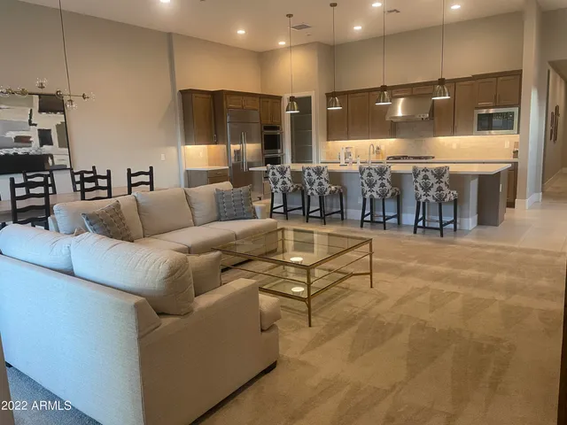 a living room with furniture and kitchen view