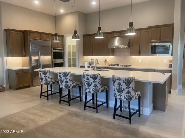 a large kitchen with a table and chairs