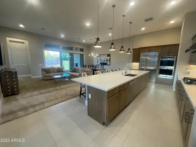 a kitchen with a stove a refrigerator and a sink