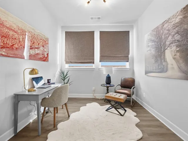 a kitchen with stainless steel appliances granite countertop a stove a sink dishwasher a refrigerator with white cabinets and wooden floor