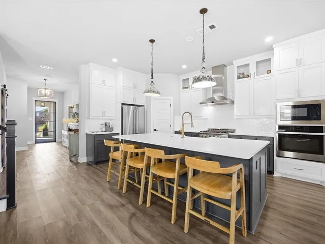 a dining table chairs refrigerator and cabinets