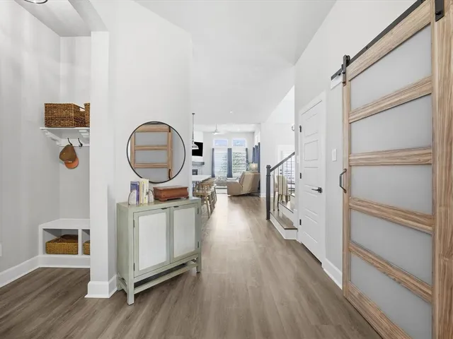 a view of a hallway with wooden floor and entryway