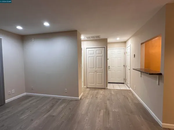 a view of a room with a ceiling fan and window