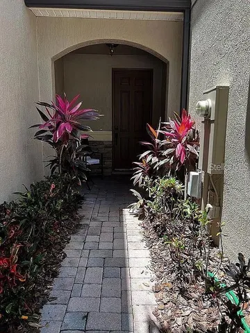 a vase with flowers sitting on a floor