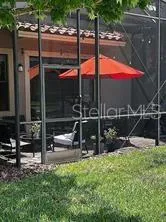 a view of a patio with a table chairs and a backyard