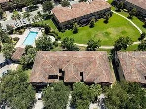an aerial view of a house by greenery space