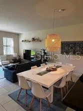 a kitchen with a dining table and chairs
