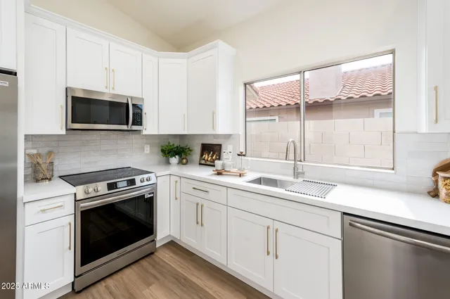 a kitchen with a sink stove and microwave