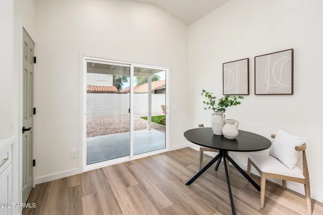 a view of a room with a table and chairs in wooden floor