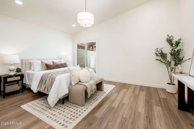 a bedroom with bed and a table