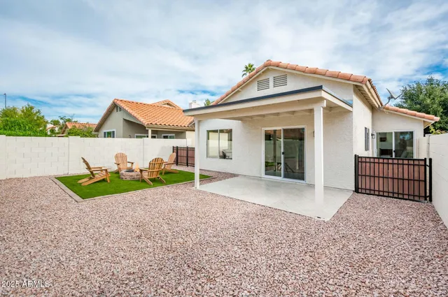 a view of a house with a yard and potted plants