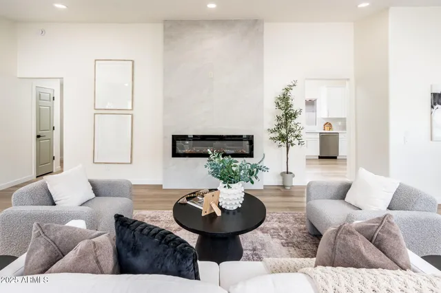 a living room with furniture and a large mirror