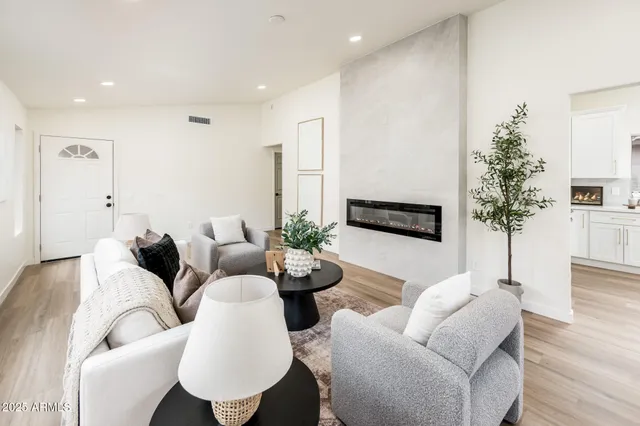 a living room with furniture potted plant and a window