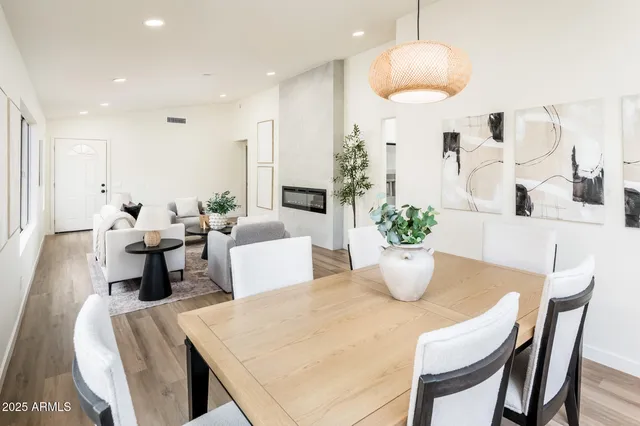 a dining room with furniture and wooden floor