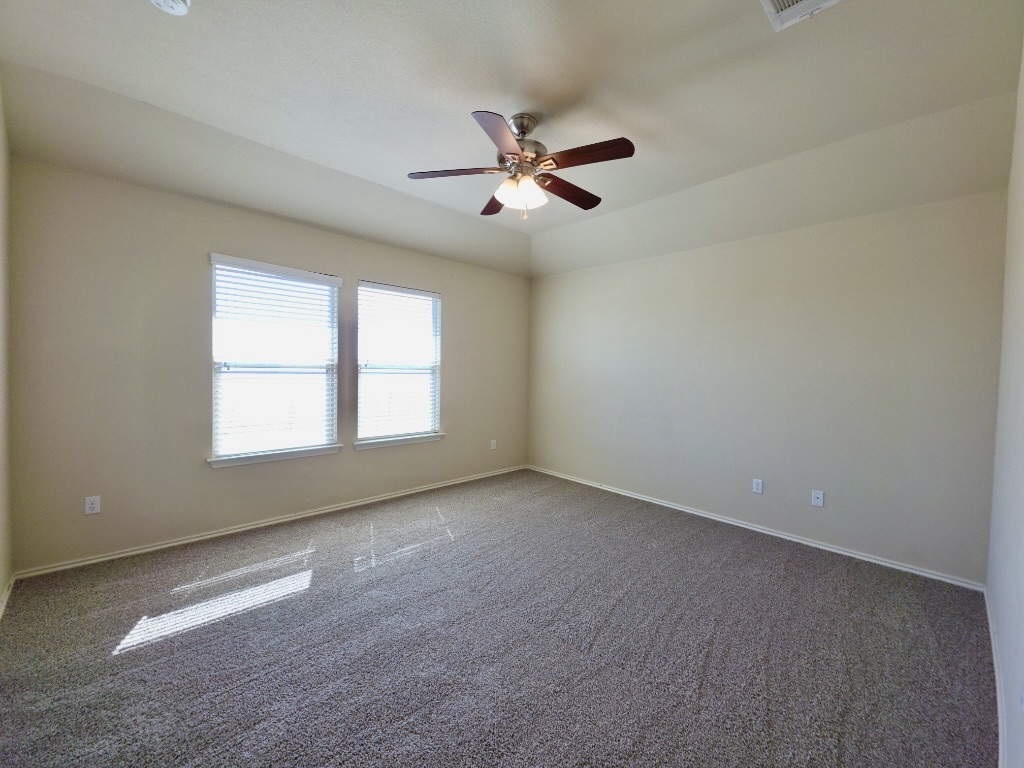 809 Yabers Court Austin, TX 78725 - Photo 13 of 29 Bedroom with baseboards and a ceiling fan
