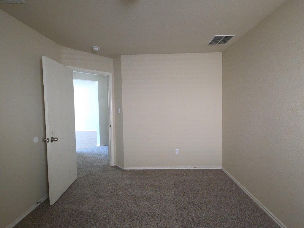 809 Yabers Court Austin, TX 78725 - Photo 20 of 29 Bedroom featuring dark colored carpet and baseboards