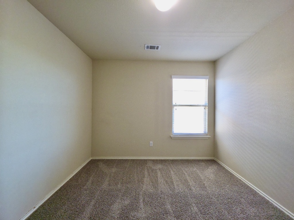 809 Yabers Court Austin, TX 78725 - Photo 22 of 29 Bedroom featuring carpet and baseboards