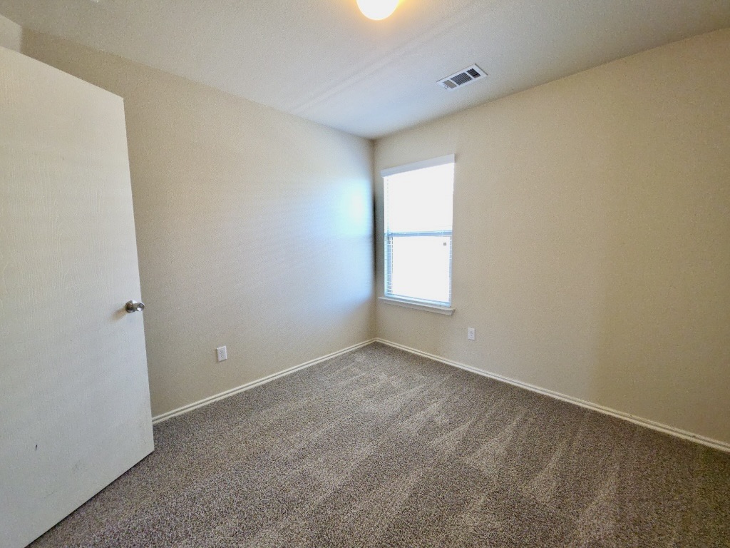 809 Yabers Court Austin, TX 78725 - Photo 25 of 29 Bedroom featuring dark carpet and baseboards