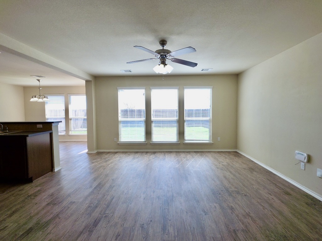 809 Yabers Court Austin, TX 78725 - Photo 3 of 29 Living room with ceiling fan and dark wood-style floors