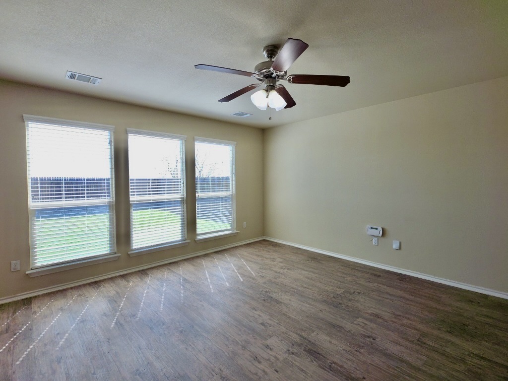 809 Yabers Court Austin, TX 78725 - Photo 4 of 29 Living room featuring a ceiling fan and dark wood-style flooring