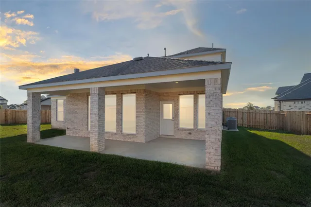 a view of an house with backyard and porch