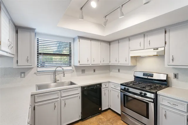 a kitchen with appliances cabinets and a sink