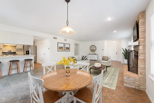 a living room with furniture and kitchen view