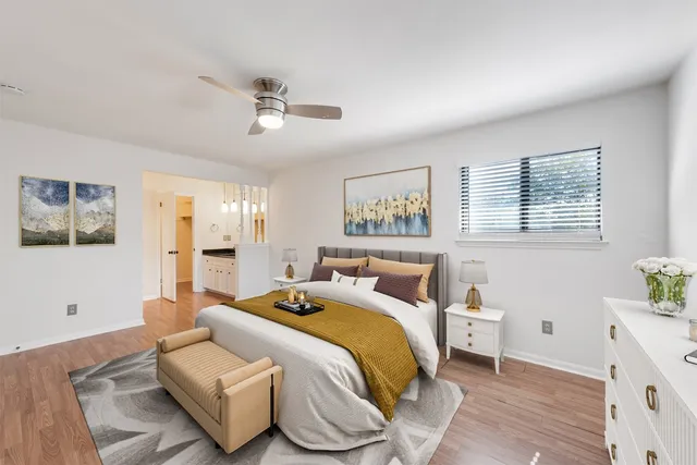 a bedroom with a bed and wooden floor