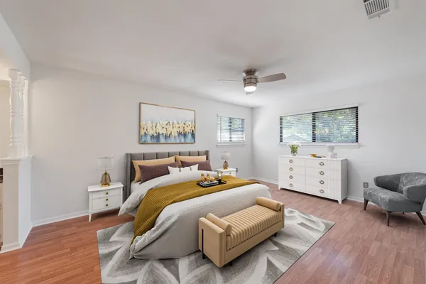 a bedroom with a bed and a chair