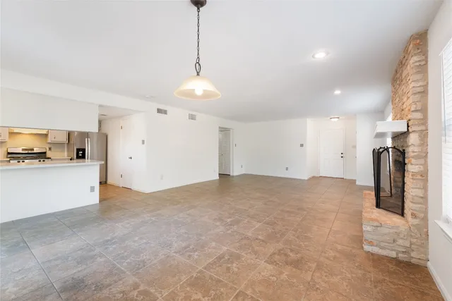 a view of a kitchen with a sink and refrigerator