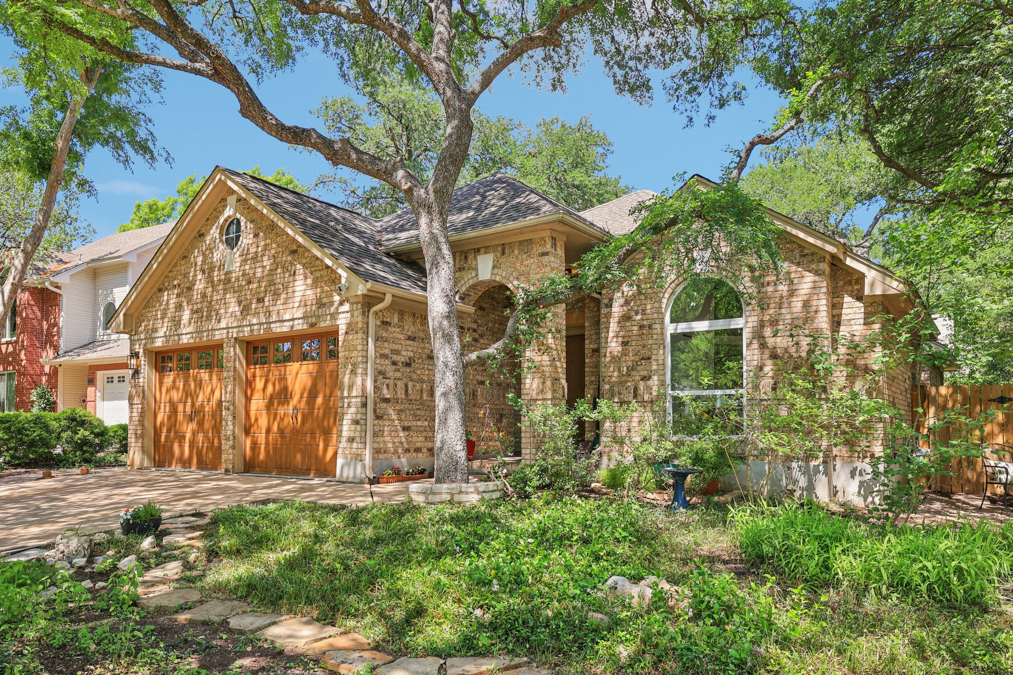 7304 John Blocker Drive Austin, TX 78749 - Photo 1 of 1 front view of house with a garden