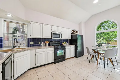 a kitchen with a sink and cabinets