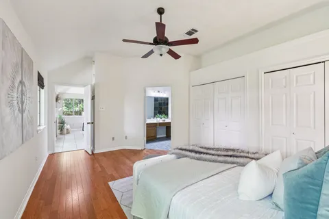 a bedroom with a bed and wooden floor
