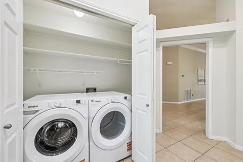 a view of a hallway with washer and dryer