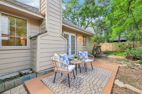 a view of a patio with a table and chairs and potted plants