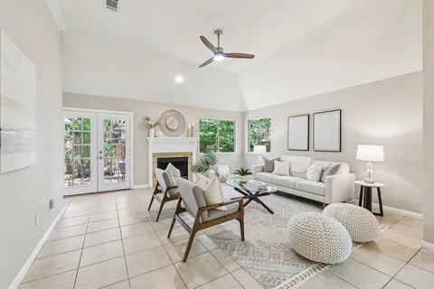 a living room with furniture a fireplace and a large window