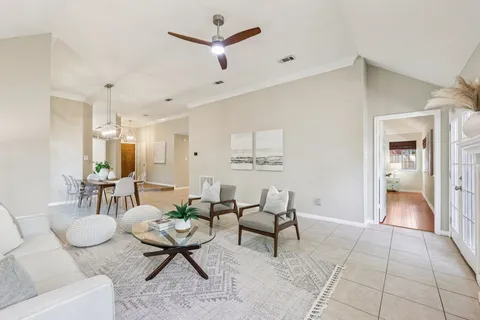 a living room with furniture and a view of kitchen