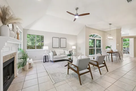 a living room with furniture a fireplace and a large window