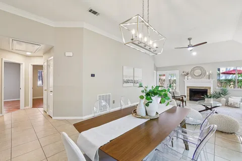 a living room with furniture a fireplace and a chandelier
