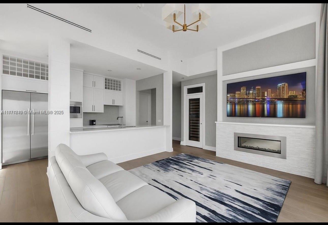 900 Brickell Key Boulevard, Unit 2904 Miami, FL 33131 - Photo 3 of 21 a living room with stainless steel appliances furniture a fireplace and a flat screen tv