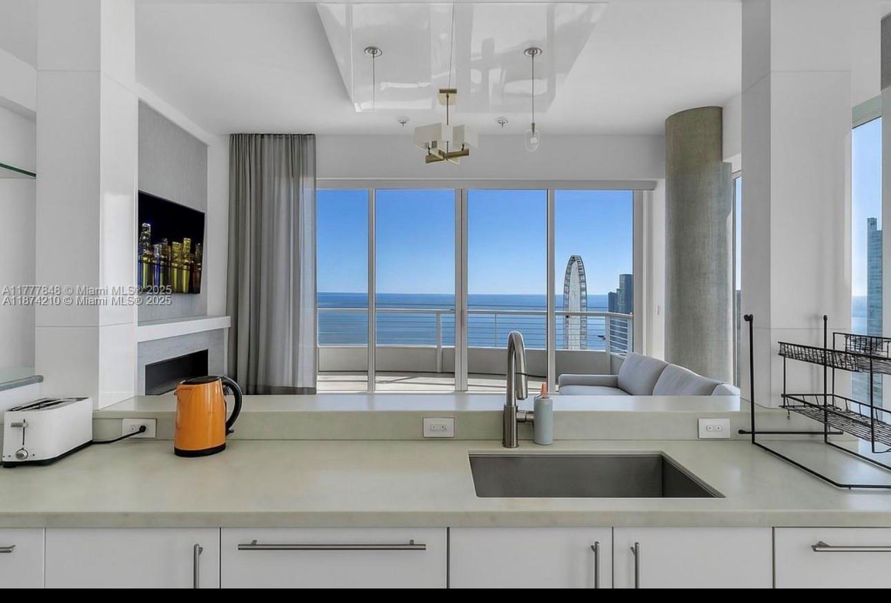 900 Brickell Key Boulevard, Unit 2904 Miami, FL 33131 - Photo 6 of 21 a kitchen with a sink and a refrigerator