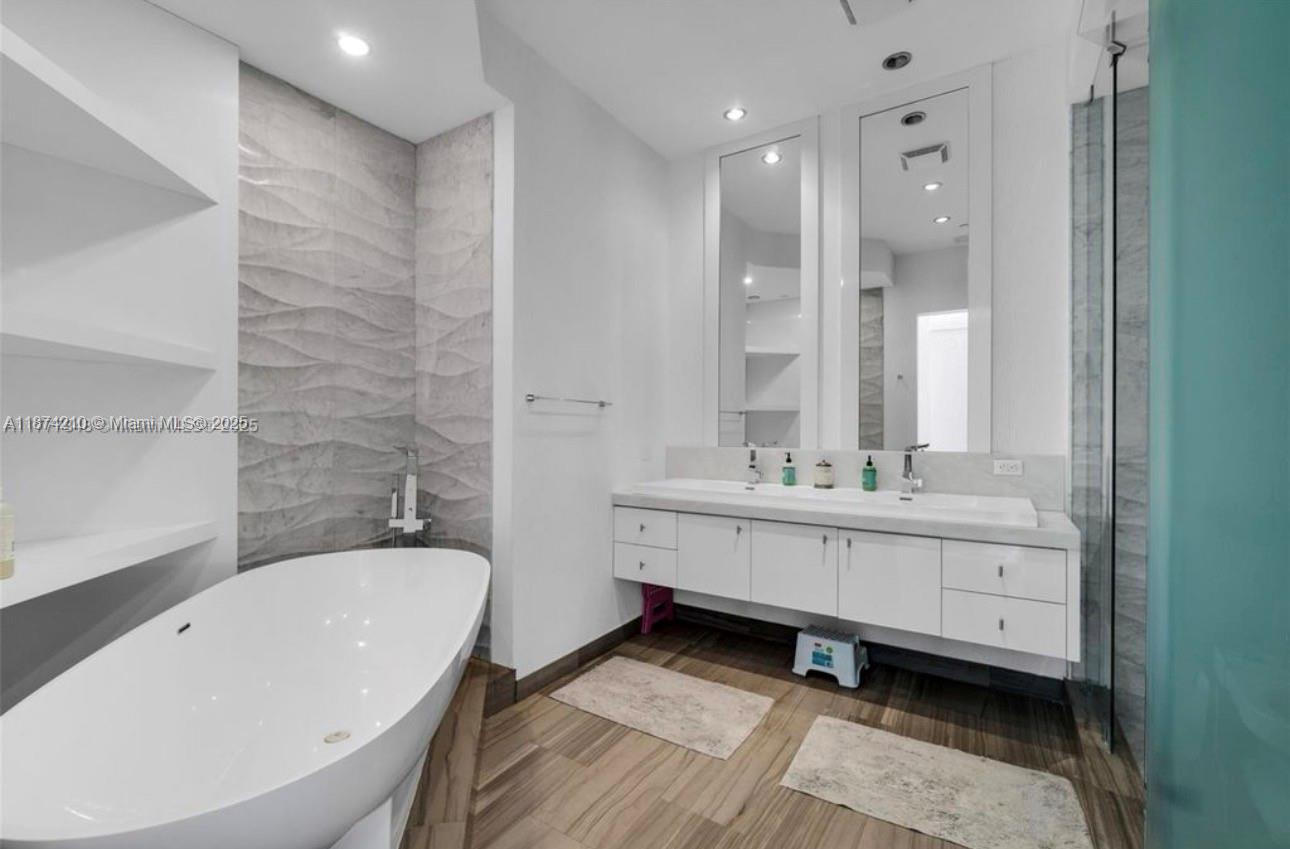 900 Brickell Key Boulevard, Unit 2904 Miami, FL 33131 - Photo 7 of 21 a bathroom with a double vanity sink mirror and bathtub