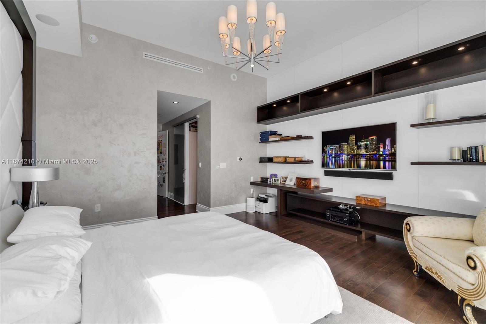 900 Brickell Key Boulevard, Unit 2904 Miami, FL 33131 - Photo 10 of 21 a bedroom with a bed and a chandelier