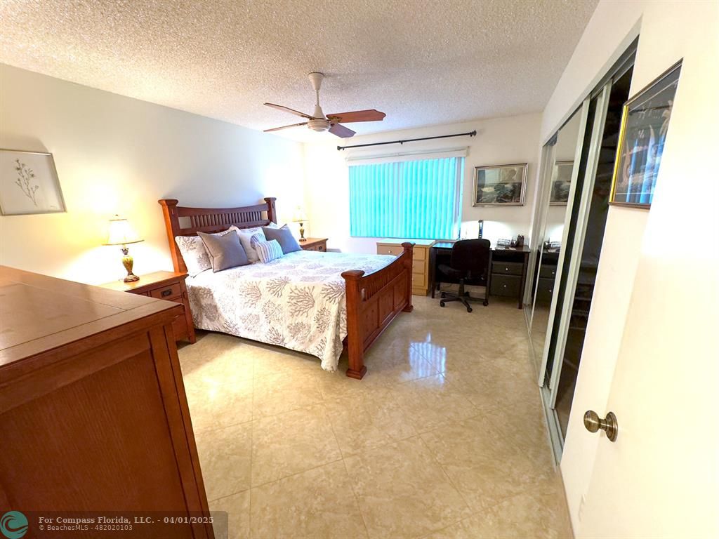 4525 Northwest 3rd Court Delray Beach, FL 33445 - Photo 14 of 23 a bedroom with a bed and wooden floor