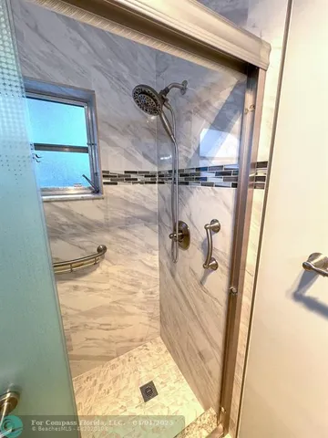 a bathroom with a glass shower door