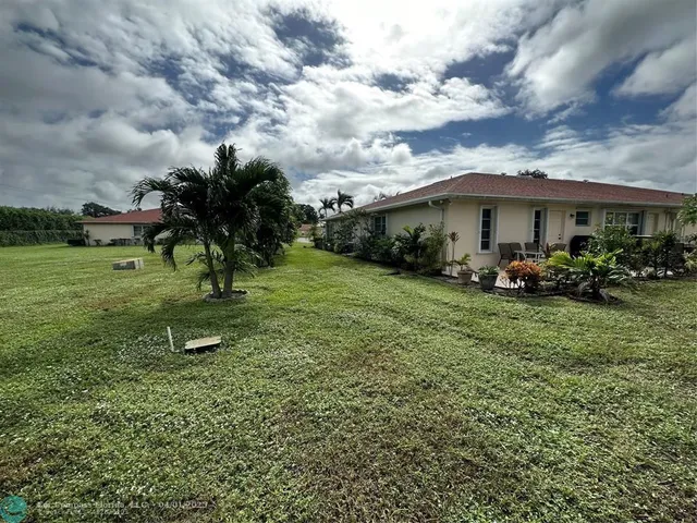 a view of a garden with a house