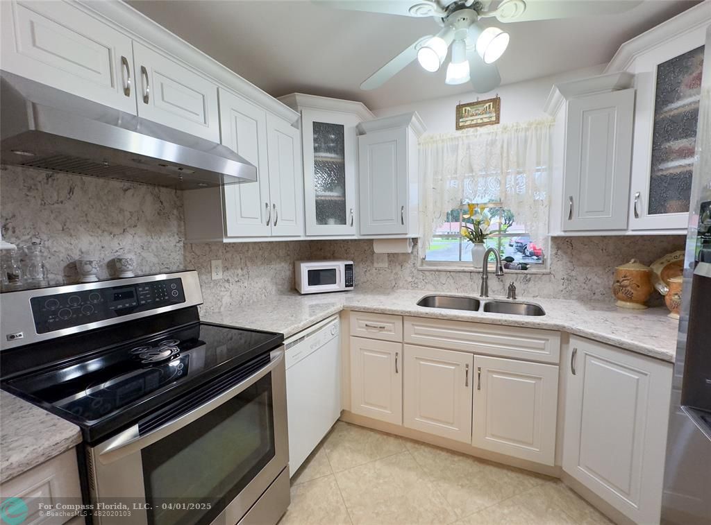 4525 Northwest 3rd Court Delray Beach, FL 33445 - Photo 4 of 23 a kitchen with a sink appliances and cabinets