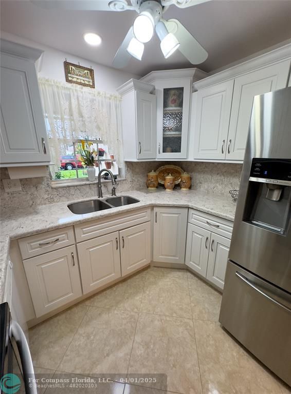 4525 Northwest 3rd Court Delray Beach, FL 33445 - Photo 6 of 23 a kitchen with a sink cabinets and stainless steel appliances