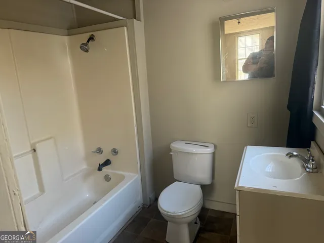 a bathroom with a sink toilet and bathtub
