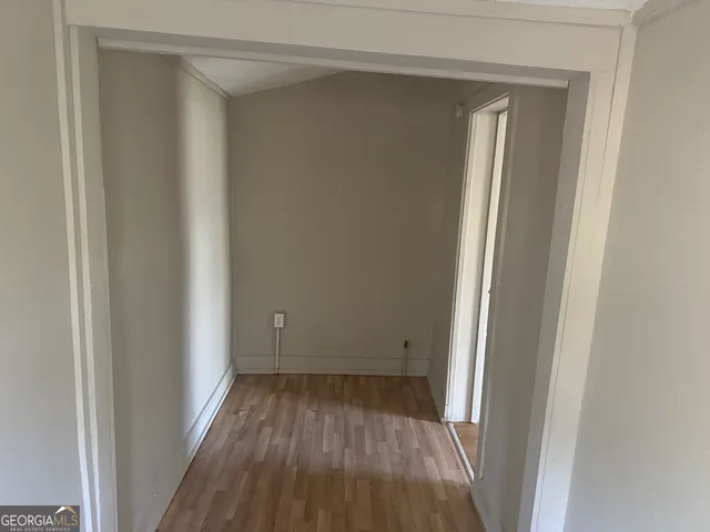 a view of a room with wooden floor